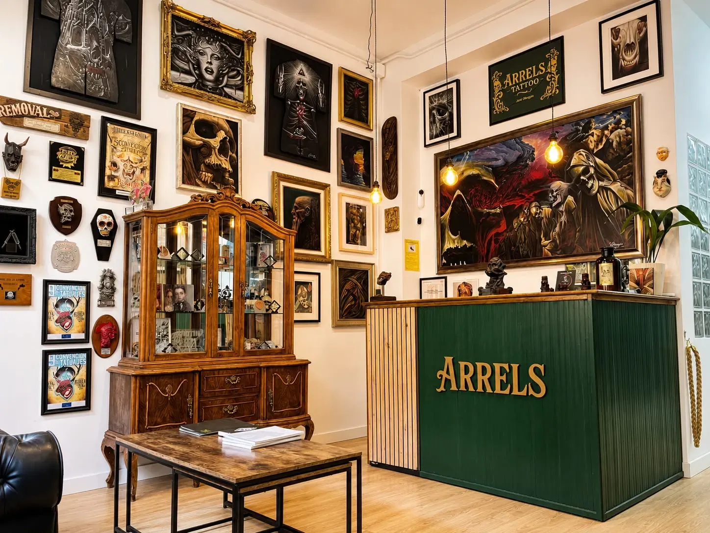 Arrels Tattoo reception with original artwork and the studio counter