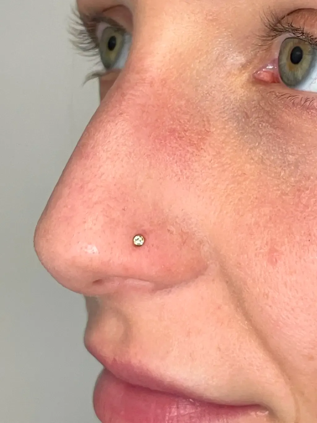 Nostril with Crystal, piercing work performed by Ramiro at Arrels Tattoo